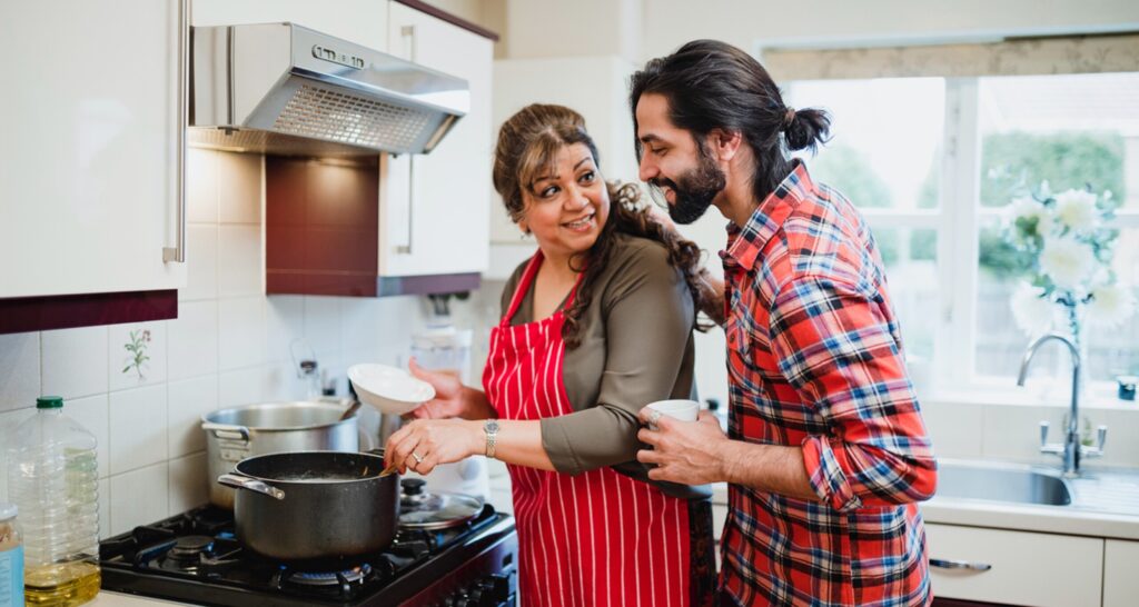 Mother and son cook together in the kitchen